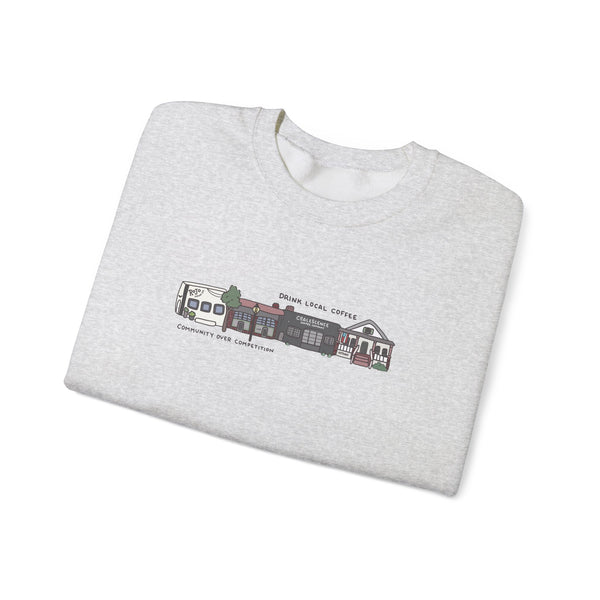 Folded gray sweatshirt with a colorful graphic and text on a white background