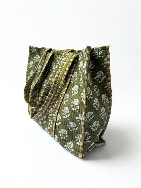 Green patterned fabric folded on a white background