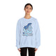 Person wearing a light blue sweatshirt with a graphic design and text on a white background